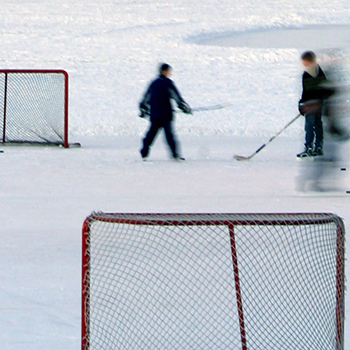 kids playing hockey on rink