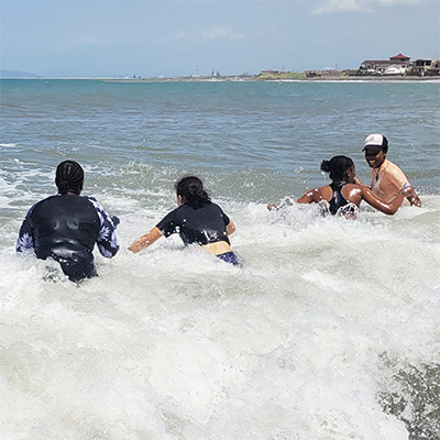 Young woman surfing in the ocean
